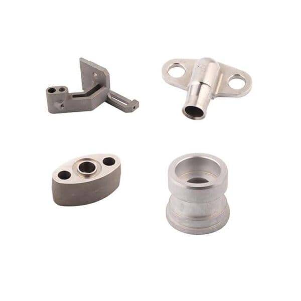 Four machined metal parts with different shapes and holes are displayed on a white background.