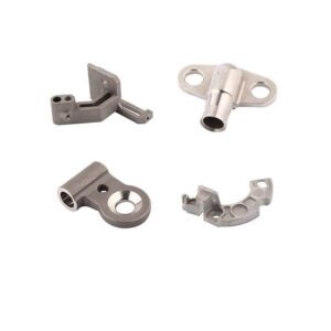 Four metal mechanical parts of different shapes, holes, and slots on a white background.