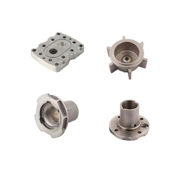 Four precision-machined metal parts with various shapes and holes are displayed on a white background.