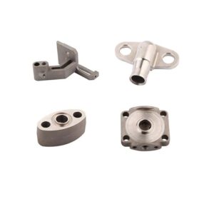 Four small machined metal parts with various holes and shapes are arranged on a white background.
