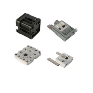 Four metallic mechanical parts spaced apart on a white background.