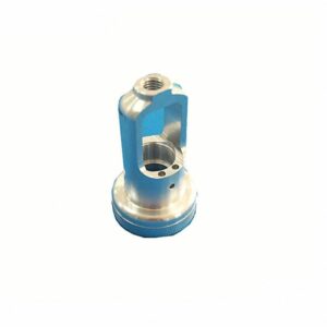 Kleines Metallteil mit blauer Oberfläche, runder Basis, gebohrten Löchern und einem Gewindeloch oben.