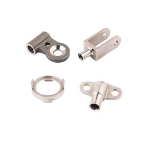 Four small metal mechanical parts with varied shapes and openings are shown on a white background.