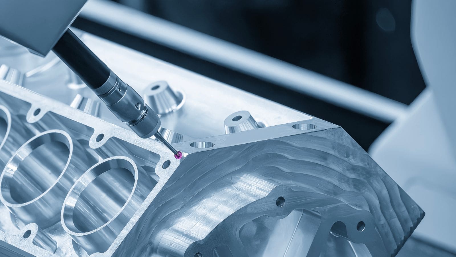a die casting engine block being tested by a CMM machine for dimensional accuracy