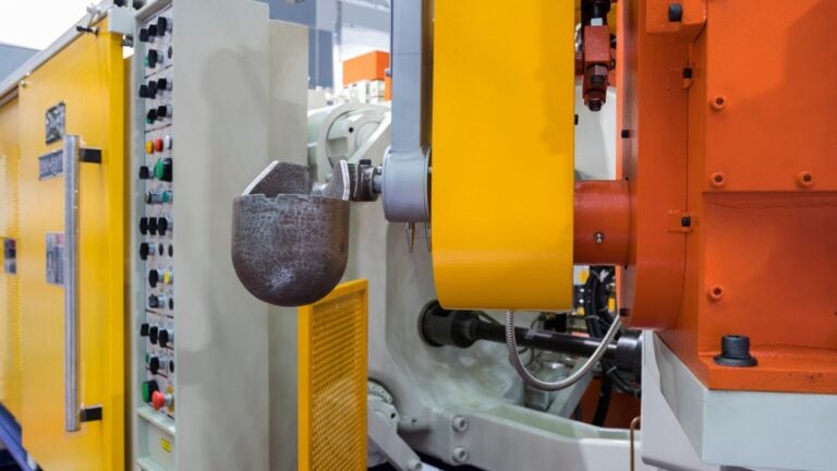 Close-up of a die casting machine showing the mold and hydraulic components used in metal casting processes.