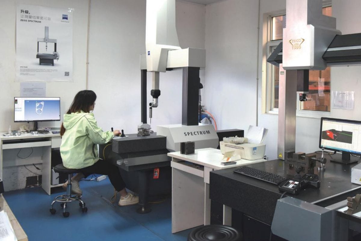 Laboratory technician operating high-precision mold casting machinery in a modern industrial facility.