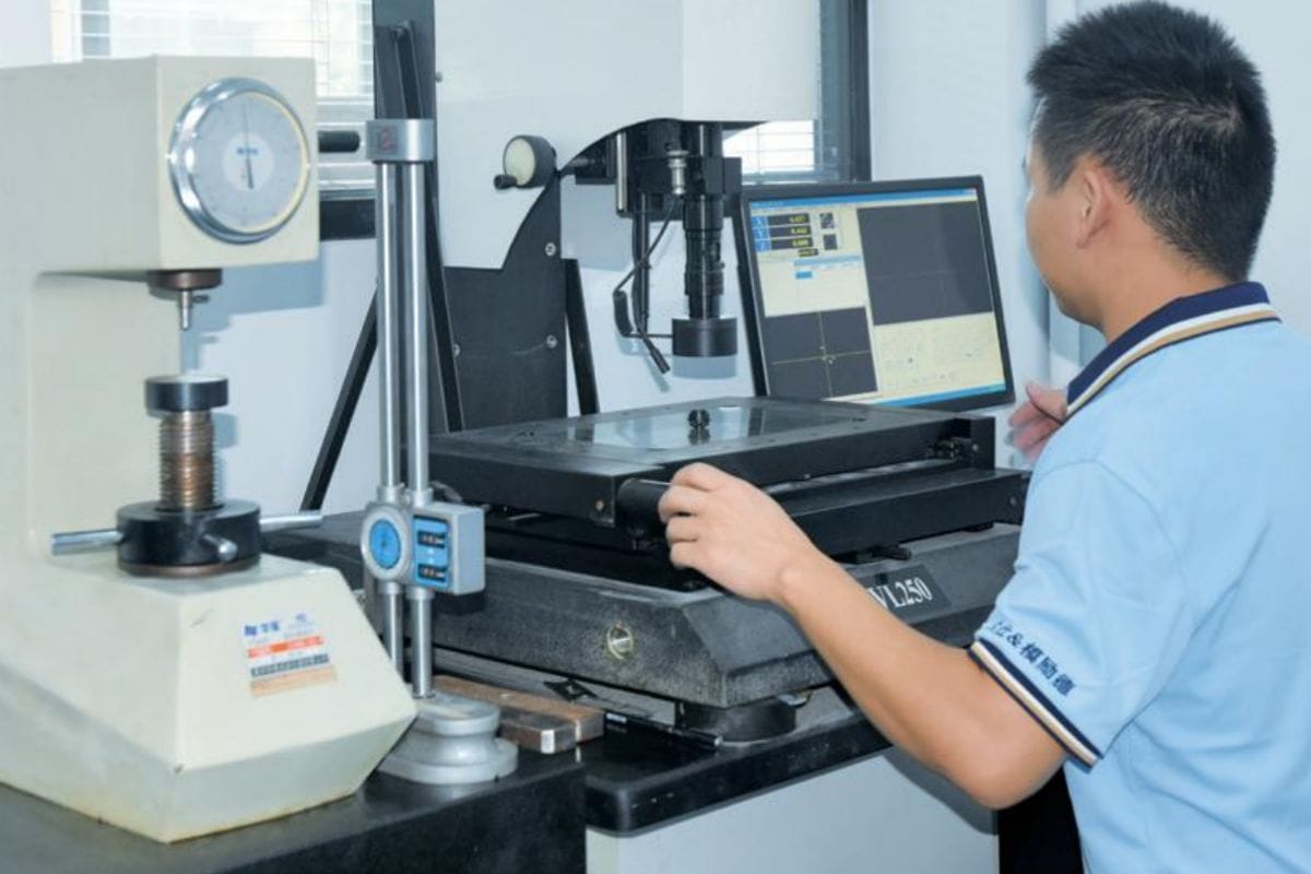 Technician operating advanced testing equipment for mold quality control at Moldie, ensuring high standards in casting processes.